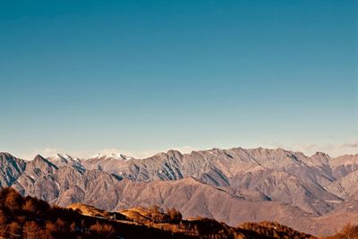 Scenic view of snowcapped mountains against clear blue sky