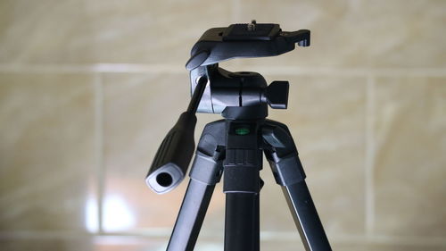 Close-up of tripod against wall