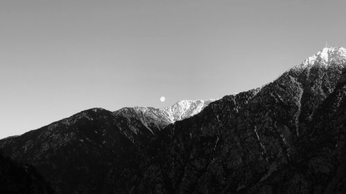 Low angle view of snowcapped mountains against sky