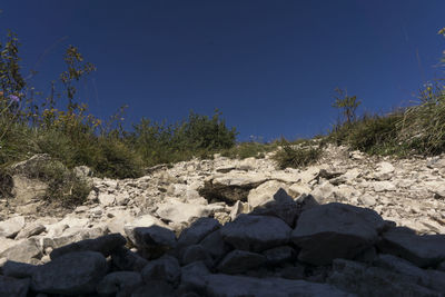 Rocks on beach against sky