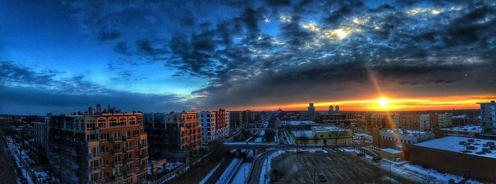 Buildings against cloudy sky