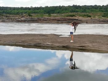 Full length of man standing on beach