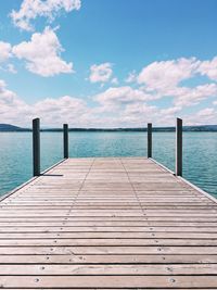 Pier over sea against blue sky