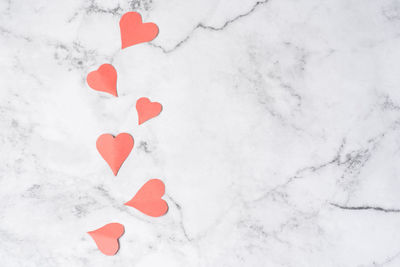 High angle view of red heart shape on snow