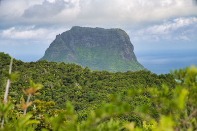 Scenic view of sea and mountains against sky