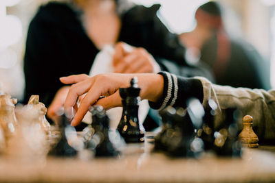 Cropped image of people playing chess