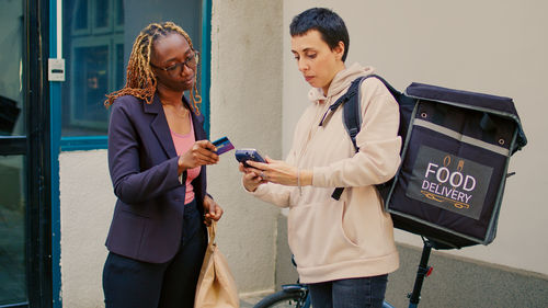 Side view of young woman using digital tablet