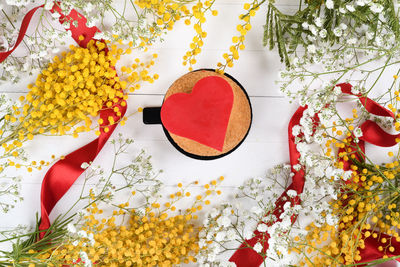 Close-up of red flowering plant on table