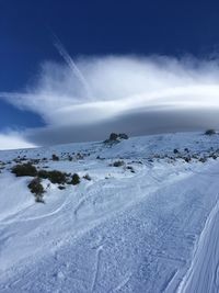 Scenic view of snow covered landscape against sky