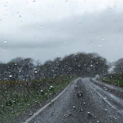 Road seen through wet windshield