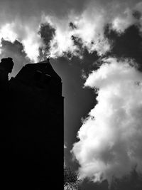 Low angle view of building against cloudy sky