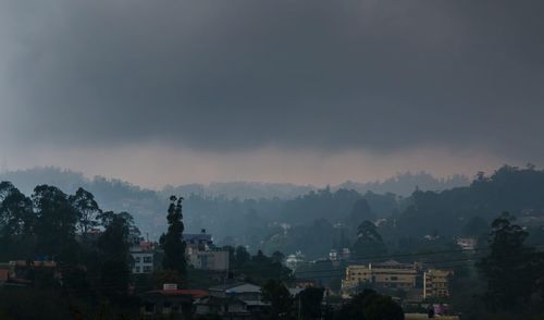 View of city against cloudy sky