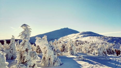 Panoramic shot of snow covered landscape against sky