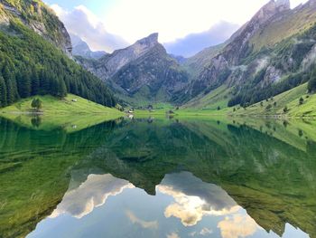 Scenic view of lake and mountains against sky