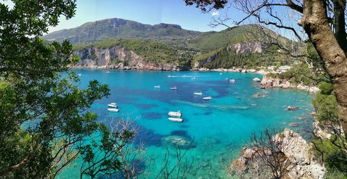 Scenic view of sea and mountains against sky