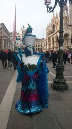 People in town square against sky