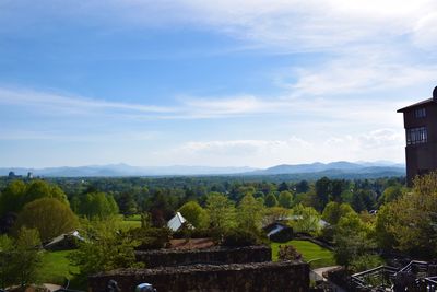 Scenic view of trees and buildings against sky