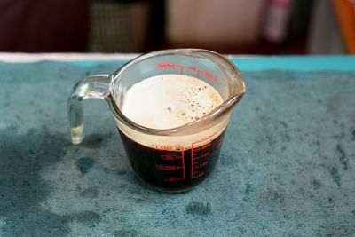 Preparing a coffee completed from the machine to pour in a ice coffee glass.