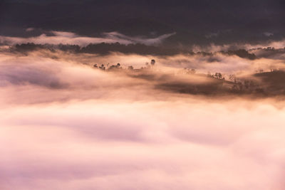 High angle view of silhouette mountains covered with clouds