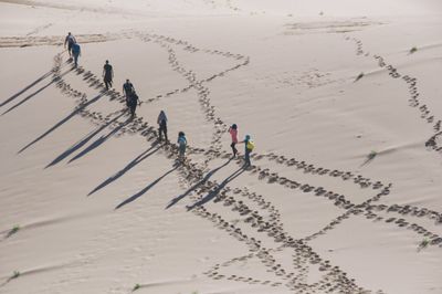 People walking on sand in desert