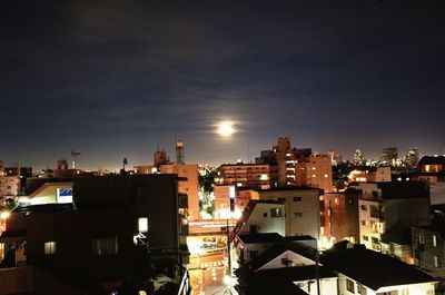 High angle view of illuminated buildings against sky at night