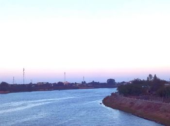 View of city at waterfront during sunset