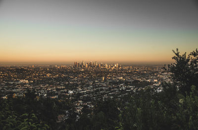 Aerial view of city buildings during sunset