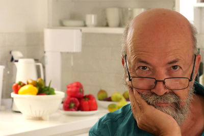 Portrait of senior man looking at home
