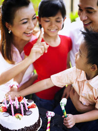 Family celebrating birthday in lawn