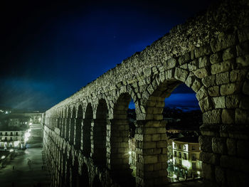 Illuminated bridge against sky at night