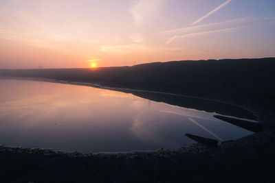 Scenic view of lake against sky during sunset