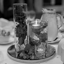 Close-up of water and flowers on table