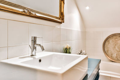 Close-up of faucet in bathroom at home