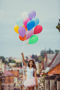 Woman holding balloons