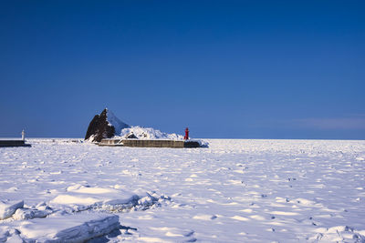 Scenic view of sea against clear blue sky