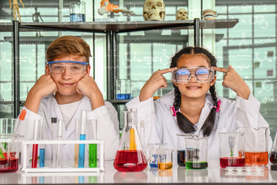 Portrait of confident students sitting in laboratory