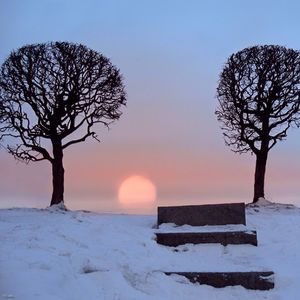 Snow covered landscape at sunset