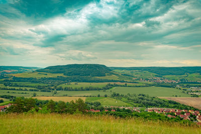 Scenic view of agricultural field against sky