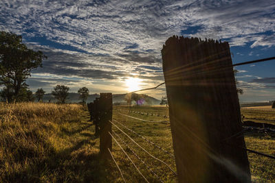 Scenic view of field against sky during sunset