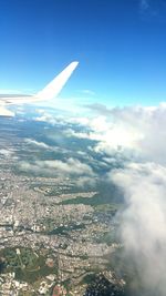 Cropped image of airplane wing over landscape