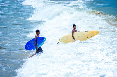 People surfing in sea