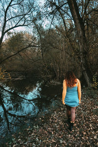 Rear view of woman walking in forest