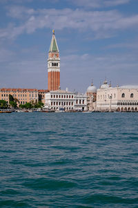 View of building by sea against sky