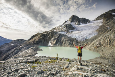 Rear view of backpacker looking at beautiful mountain view.