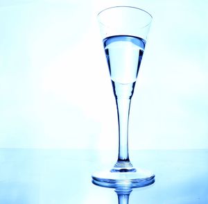 Close-up of glass of water against white background