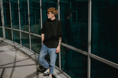 Full length of young man standing in city