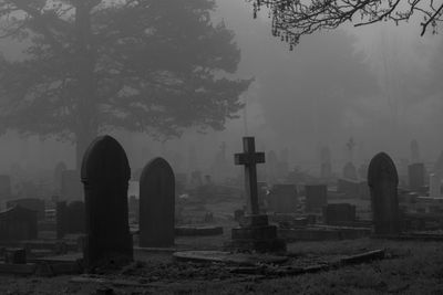 View of cemetery against sky during foggy weather