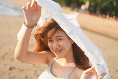 Portrait of smiling young woman at beach