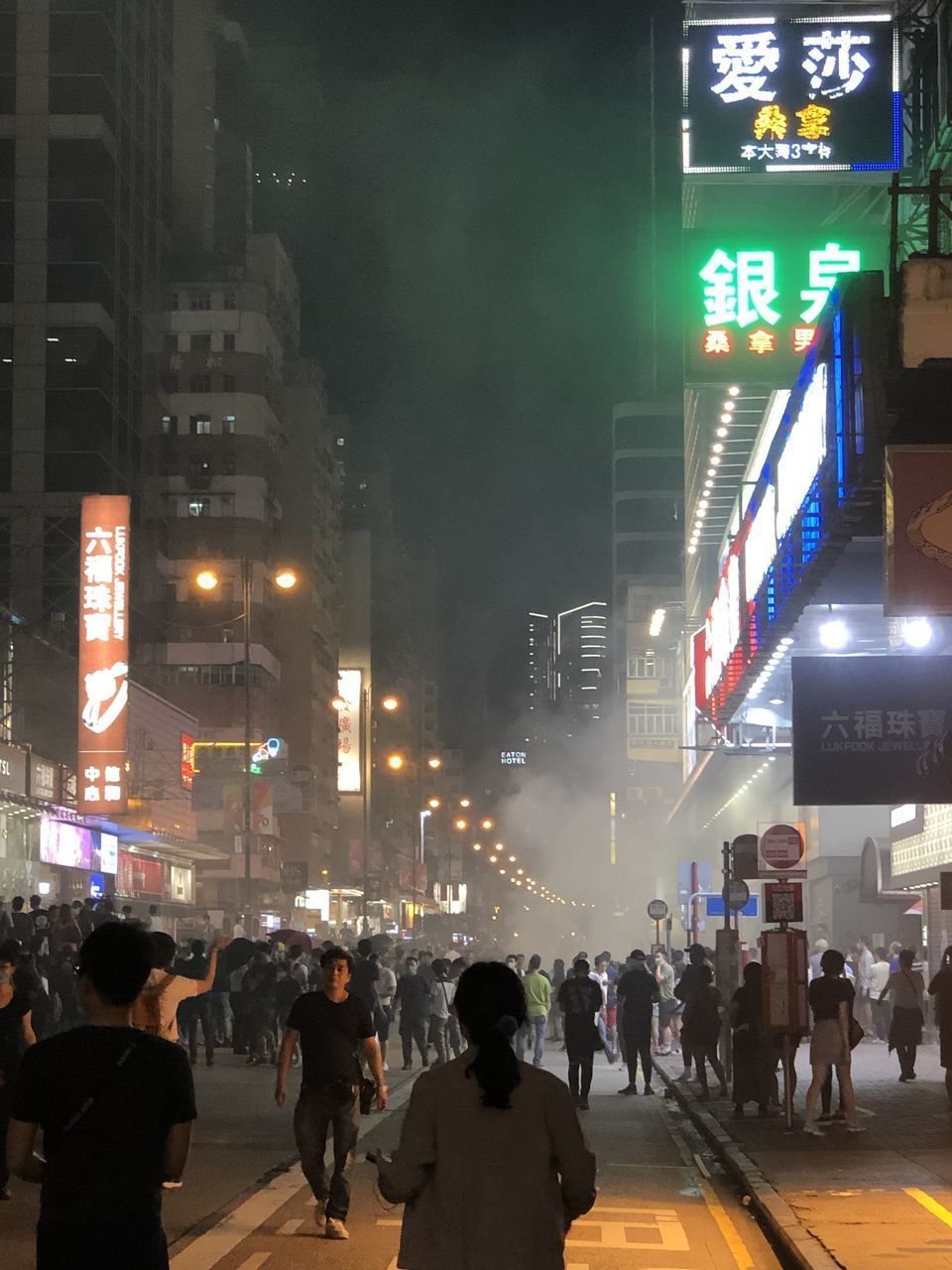 GROUP OF PEOPLE WALKING ON ROAD IN CITY