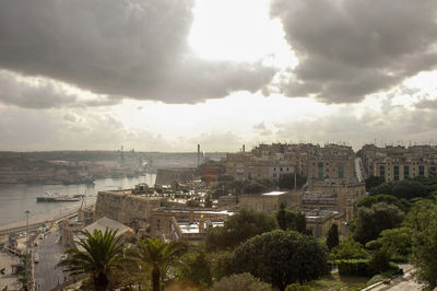 High angle view of buildings in town against sky